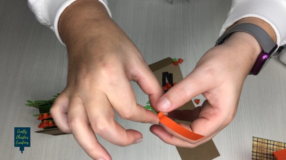 roll the orange strips into small rolled mum flowers